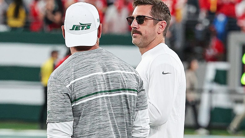 Oct 1, 2023; East Rutherford, New Jersey, USA; New York Jets quarterback Aaron Rodgers (8) talks with a member of the Jets staff before the game against the Kansas City Chiefs at MetLife Stadium. Mandatory Credit: Vincent Carchietta-USA TODAY Sports