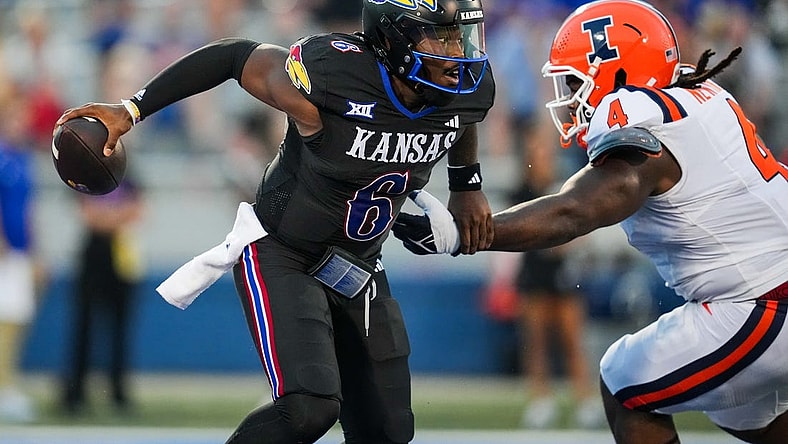 Sep 8, 2023; Lawrence, Kansas, USA; Kansas Jayhawks quarterback Jalon Daniels (6) against Illinois Fighting Illini defensive lineman Jer'Zhan Newton (4) during the first half at David Booth Kansas Memorial Stadium. Mandatory Credit: Jay Biggerstaff-USA TODAY Sports