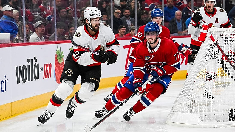 Sep 27, 2023; Montreal, Quebec, CAN; Montreal Canadiens center Kirby Dach (77) defends the puck against Ottawa Senators left wing Jiri Smejkal (13) during the second period at Bell Centre. Mandatory Credit: David Kirouac-USA TODAY Sports