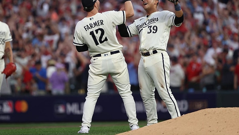 Oct 3, 2023; Minneapolis, Minnesota, USA; Minnesota Twins third baseman Kyle Farmer (12) and first baseman Donovan Solano (39) celebrated after defeating Toronto Blue Jays  during game one of the Wildcard series for the 2023 MLB playoffs at Target Field. Mandatory Credit: Jesse Johnson-USA TODAY Sports