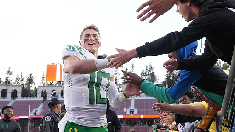 Sep 30, 2023; Stanford, California, USA; Oregon Ducks quarterback Bo Nix (10) celebrates with fans after defeating the Stanford Cardinal at Stanford Stadium. Mandatory Credit: Darren Yamashita-USA TODAY Sports