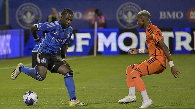 Oct 4, 2023; Montreal, Quebec, CAN; CF Montreal defender Zachary Brault-Guillard (15) dribbles against Houston Dynamo forward Nelson Quinones (21) during the first half at Stade Saputo. Mandatory Credit: Eric Bolte-USA TODAY Sports