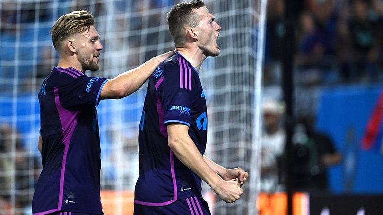 Oct 4, 2023; Charlotte, North Carolina, USA; Charlotte FC forward Karol   widerski (11) celebrates with midfielder Kamil J    wiak (7) after scoring his second goal in the first half at Bank of America Stadium. Mandatory Credit: Bob Donnan-USA TODAY Sports
