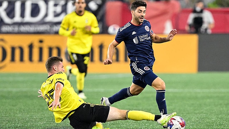 Oct 4, 2023; Foxborough, Massachusetts, USA; Columbus Crew midfielder Sean Zawadzki (25) defends New England Revolution midfielder Carles Gil (10) during the first half at Gillette Stadium. Mandatory Credit: Brian Fluharty-USA TODAY Sports