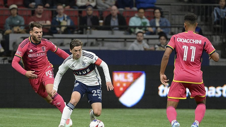 Oct 4, 2023; Vancouver, British Columbia, CAN;  Vancouver Whitecaps FC midfielder Ryan Gauld (25) controls the ball against St. Louis City SC midfielder Eduard Lowen (10) during the first half at BC Place. Mandatory Credit: Anne-Marie Sorvin-USA TODAY Sports