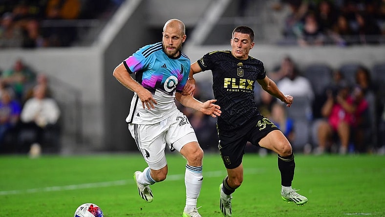 Oct 4, 2023; Los Angeles, California, USA; Los Angeles FC defender Sergi Palencia (30) plays for the ball against Minnesota United forward Teemu Pukki (22) during the first half at BMO Stadium. Mandatory Credit: Gary A. Vasquez-USA TODAY Sports