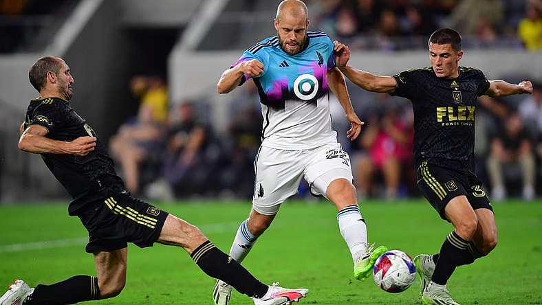 Oct 4, 2023; Los Angeles, California, USA; Los Angeles FC defender Sergi Palencia (30) and defender Giorgio Chiellini (14) play for the ball against Minnesota United forward Teemu Pukki (22) during the first half at BMO Stadium. Mandatory Credit: Gary A. Vasquez-USA TODAY Sports
