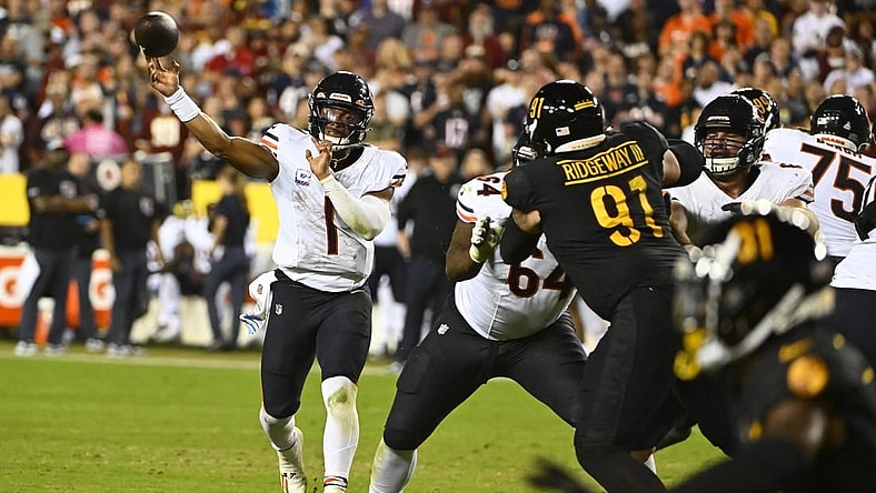 Oct 5, 2023; Landover, Maryland, USA; Chicago Bears quarterback Justin Fields (1) passes the ball as Washington Commanders defensive tackle John Ridgeway (91) defends during the first half at FedExField. Mandatory Credit: Brad Mills-USA TODAY Sports
