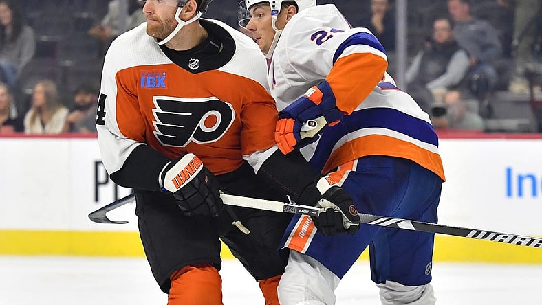 Oct 5, 2023; Philadelphia, Pennsylvania, USA; Philadelphia Flyers center Sean Couturier (14) and New York Islanders defenseman Scott Mayfield (24) battle for position during the third period at Wells Fargo Center. Mandatory Credit: Eric Hartline-USA TODAY Sports