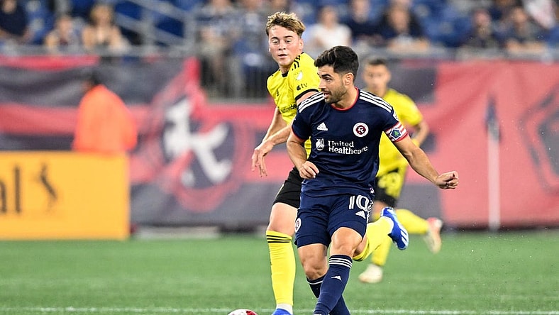 Oct 4, 2023; Foxborough, Massachusetts, USA; New England Revolution midfielder Carles Gil (10) passes the ball against the Columbus Crew during the first half at Gillette Stadium. Mandatory Credit: Brian Fluharty-USA TODAY Sports