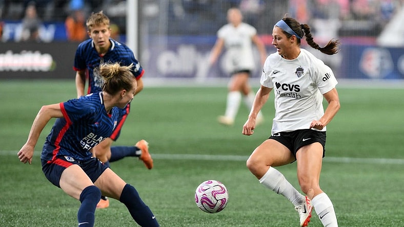 Oct 6, 2023; Seattle, Washington, USA; Washington Spirit forward Ashley Hatch (33) and OL Reign defender Emily Sonnett (2) battle for the ball during the second half at Lumen Field. Mandatory Credit: Steven Bisig-USA TODAY Sports