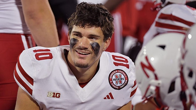 Oct 6, 2023; Champaign, Illinois, USA; Nebraska Cornhuskers quarterback Heinrich Haarberg (10) smiles with teammates on the bench during the second half against the Illinois Fighting Illini at Memorial Stadium. Mandatory Credit: Ron Johnson-USA TODAY Sports