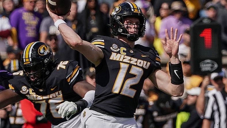 Oct 7, 2023; Columbia, Missouri, USA; Missouri Tigers quarterback Brady Cook (12) throws a pass against the LSU Tigers during the first half at Faurot Field at Memorial Stadium. Mandatory Credit: Denny Medley-USA TODAY Sports