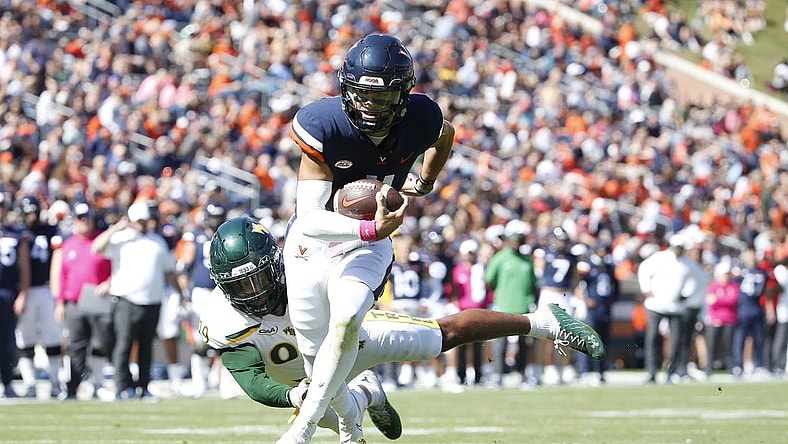 Oct 7, 2023; Charlottesville, Virginia, USA; Virginia Cavaliers quarterback Tony Muskett (11) scores a touchdown past William & Mary Tribe defensive lineman Nate Lynn (99) during the first half at Scott Stadium. Mandatory Credit: Amber Searls-USA TODAY Sports