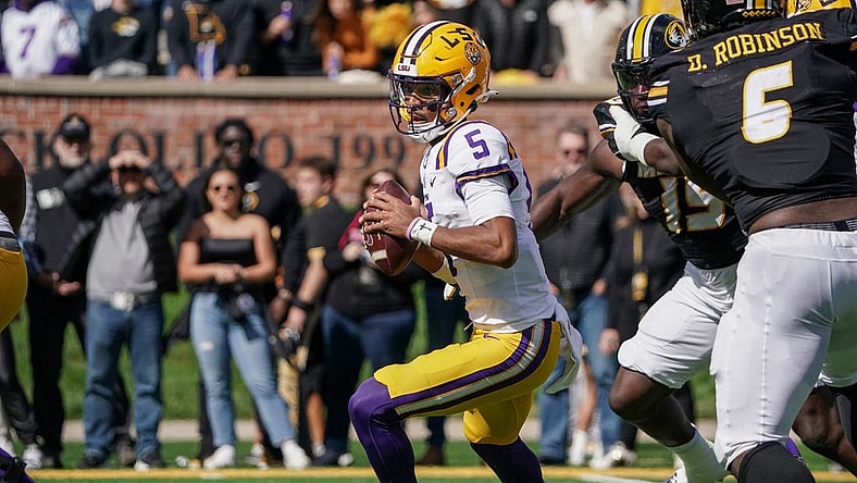 Oct 7, 2023; Columbia, Missouri, USA; LSU Tigers quarterback Jayden Daniels (5) drops back to pass against the Missouri Tigers during the first half at Faurot Field at Memorial Stadium. Mandatory Credit: Denny Medley-USA TODAY Sports