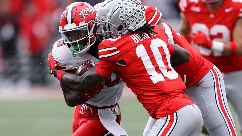 Oct 7, 2023; Columbus, Ohio, USA;  Maryland Terrapins wide receiver Tai Felton (10) runs the ball as Ohio State Buckeyes cornerback Denzel Burke (10) makes the tackle during the second quarter at Ohio Stadium. Mandatory Credit: Joseph Maiorana-USA TODAY Sports