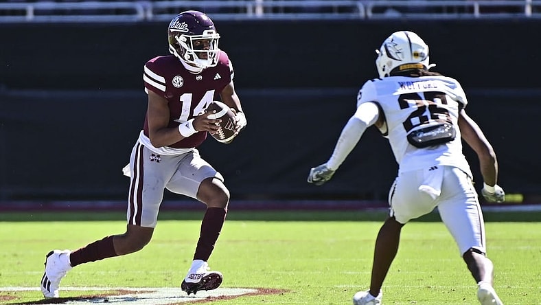 Oct 7, 2023; Starkville, Mississippi, USA; Mississippi State Bulldogs quarterback Mike Wright (14) runs the ball while defended by Western Michigan Broncos cornerback Aaron Wofford (25) during the fourth quarter at Davis Wade Stadium at Scott Field. Mandatory Credit: Matt Bush-USA TODAY Sports