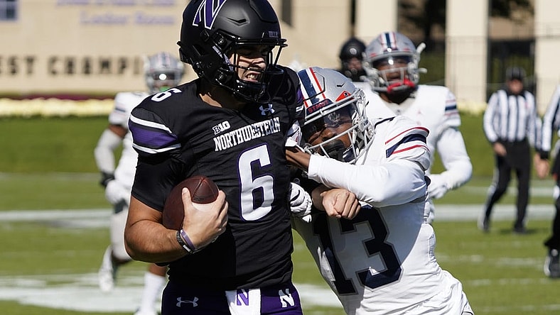 Oct 7, 2023; Evanston, Illinois, USA; Northwestern Wildcats quarterback Brendan Sullivan (6) runs for a touchdown as Howard Bison defensive back Jabari Knighten (13) defends him during the first half at Ryan Field. Mandatory Credit: David Banks-USA TODAY Sports