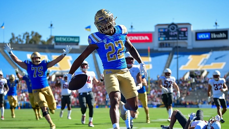 Oct 7, 2023; Pasadena, California, USA; UCLA Bruins wide receiver Keegan Jones (22) scores a touchdown against the Washington State Cougars during the second half at Rose Bowl. Mandatory Credit: Gary A. Vasquez-USA TODAY Sports