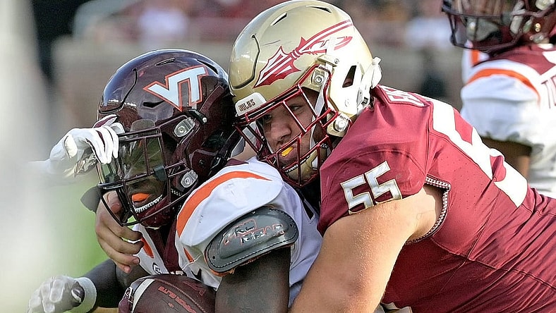 Oct 7, 2023; Tallahassee, Florida, USA; Virginia Tech Hokies running back Malachi Thomas (24) is tackled by Florida State Seminoles defensive lineman Braden Fiske (55) during the second half at Doak S. Campbell Stadium. Mandatory Credit: Melina Myers-USA TODAY Sports