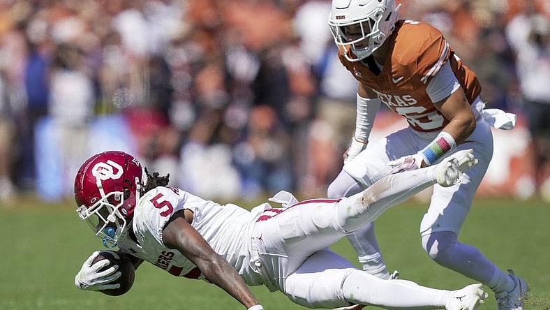Oct 7, 2023; Dallas, Texas, USA; Oklahoma Sooners wide receiver Andrel Anthony (5) fights for yardage against the Texas Longhorns at the Cotton Bowl. This game makes up the 119th rivalry match up. Mandatory Credit: Ricardo B. Brazziell-USA TODAY Sports