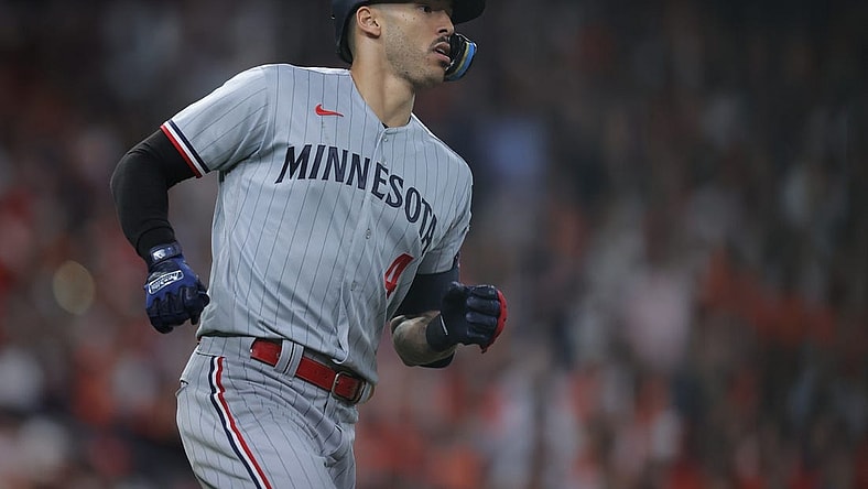 Oct 7, 2023; Houston, Texas, USA; Minnesota Twins shortstop Carlos Correa (4) hits a double in the eighth inning against the Houston Astros during game one of the ALDS for the 2023 MLB playoffs at Minute Maid Park. Mandatory Credit: Erik Williams-USA TODAY Sports