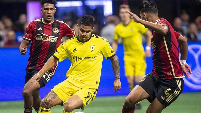 Oct 7, 2023; Atlanta, Georgia, USA; Columbus Crew forward Cucho Hernandez (9) drives against Atlanta United defender Caleb Wiley (26) and defender Luis Abram (4) at Mercedes-Benz Stadium. Mandatory Credit: Julie Bennett-USA TODAY Sports