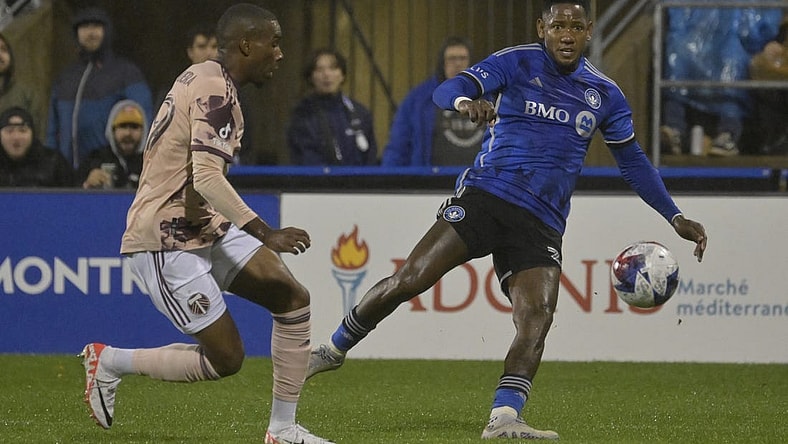 Oct 7, 2023; Montreal, Quebec, CAN; CF Montreal forward Romell Quioto (30) passes the ball against Portland Timbers defender Juan Mosquera (29) in the first half at Stade Saputo. Mandatory Credit: Eric Bolte-USA TODAY Sports
