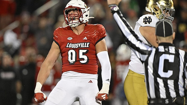Oct 7, 2023; Louisville, Kentucky, USA;  Louisville Cardinals defensive lineman Mason Reiger (95) reacts after sacking Notre Dame Fighting Irish quarterback Sam Hartman (10) during the first half at L&N Federal Credit Union Stadium. Mandatory Credit: Jamie Rhodes-USA TODAY Sports