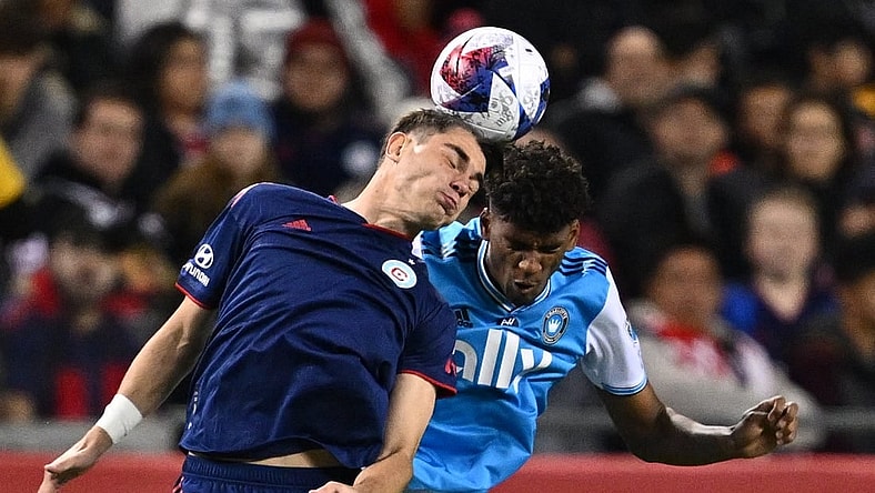 Oct 7, 2023; Chicago, Illinois, USA; Chicago Fire FC forward Georgios Koutsias (19) and Charlotte FC defender Adilson Malanda (29) battle for control of the ball in the first half at Soldier Field. Mandatory Credit: Jamie Sabau-USA TODAY Sports