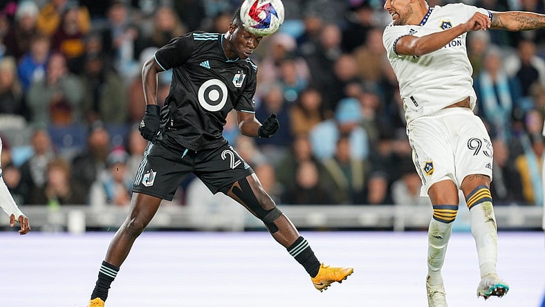 Oct 7, 2023; Saint Paul, Minnesota, USA; Minnesota United forward Bongokuhle Hlongwane (21) heads the ball against Los Angeles Galaxy defender Tony Alfaro (93) in the first half at Allianz Field. Mandatory Credit: Matt Blewett-USA TODAY Sports