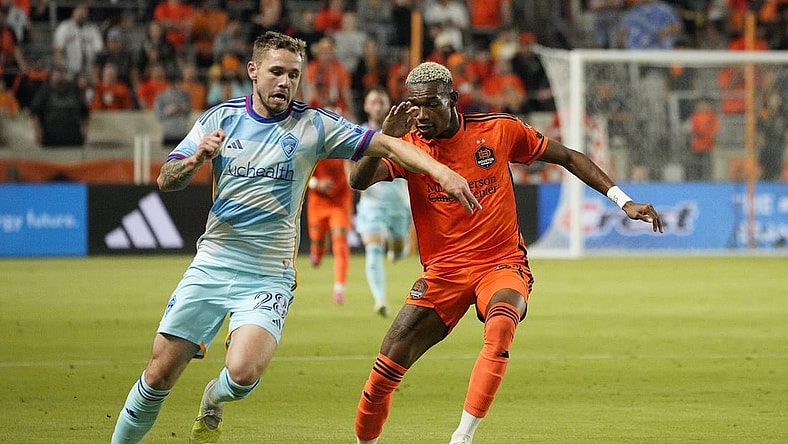 Oct 7, 2023; Houston, Texas, USA; Colorado Rapids midfielder Sam Nicholson (28) dribbles against Houston Dynamo forward Nelson Quinones (21) during the first half at Shell Energy Stadium. Mandatory Credit: Dustin Safranek-USA TODAY Sports