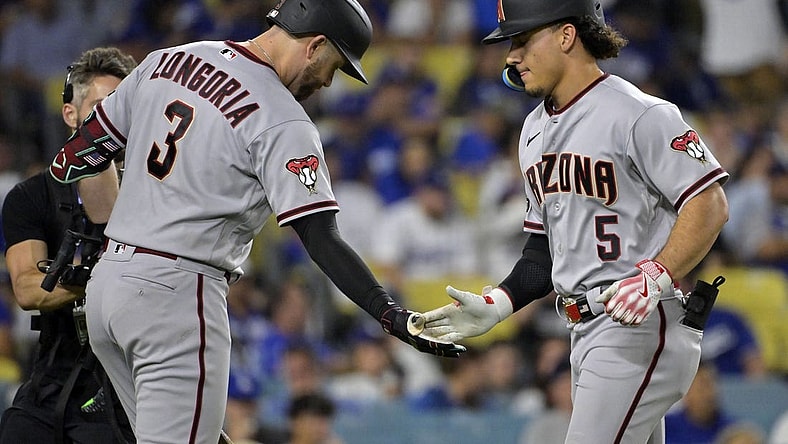 Oct 7, 2023; Los Angeles, California, USA; Arizona Diamondbacks center fielder Alek Thomas (5) reacts after hitting a home run against the Los Angeles Dodgers during the seventh inning for game one of the NLDS for the 2023 MLB playoffs at Dodger Stadium. Mandatory Credit: Jayne Kamin-Oncea-USA TODAY Sports