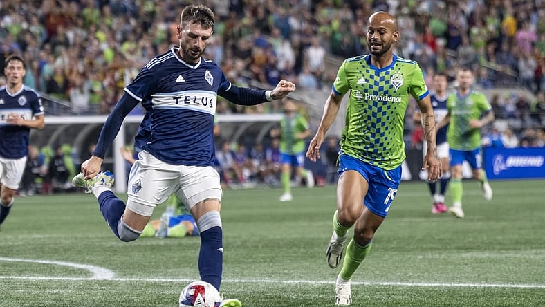 Oct 7, 2023; Seattle, Washington, USA; Vancouver Whitecaps defender Tristan Blackmon (6) passes the ball against Seattle Sounders forward Heber (19) during the second half at Lumen Field. Mandatory Credit: Stephen Brashear-USA TODAY Sports