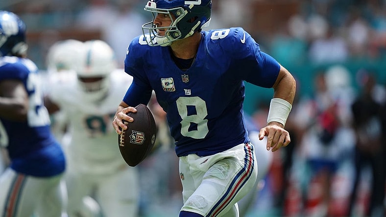 Oct 8, 2023; Miami Gardens, Florida, USA; New York Giants quarterback Daniel Jones (8) scrambles with the ball agianst the Miami Dolphins during the first half at Hard Rock Stadium. Mandatory Credit: Jasen Vinlove-USA TODAY Sports