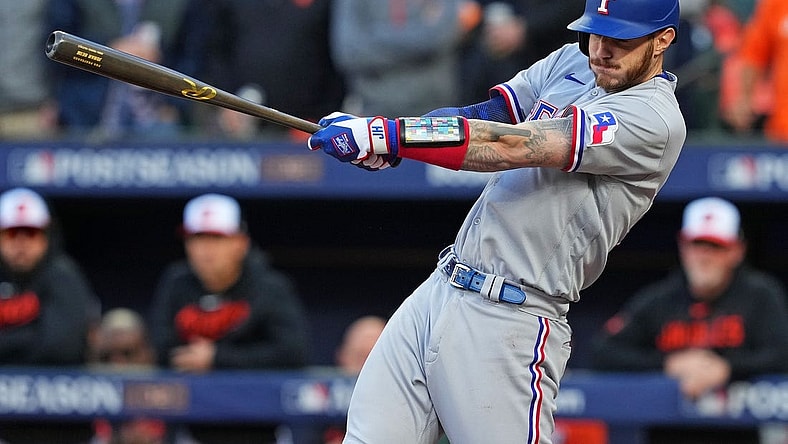 Oct 8, 2023; Baltimore, Maryland, USA; Texas Rangers catcher Jonah Heim (28) hits an RBI single during the second inning against the Baltimore Orioles during game two of the ALDS for the 2023 MLB playoffs at Oriole Park at Camden Yards. Mandatory Credit: Mitch Stringer-USA TODAY Sports