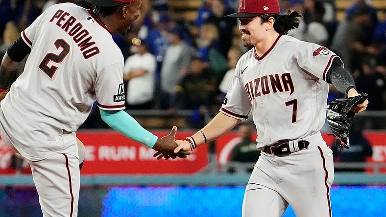 Arizona Diamondbacks shortstop Geraldo Perdomo (2) and Arizona Diamondbacks right fielder Corbin Carroll (7) celebrate their 4-2 win over the Los Angeles Dodgers during Game 2 of the NLDS at Dodger Stadium in Los Angeles on Oct. 9, 2023.