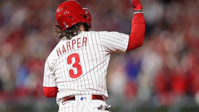 Oct 11, 2023; Philadelphia, Pennsylvania, USA; Philadelphia Phillies first baseman Bryce Harper (3) hits a solo during the fifth inning against the Atlanta Braves in game three of the NLDS for the 2023 MLB playoffs at Citizens Bank Park. Mandatory Credit: Bill Streicher-USA TODAY Sports