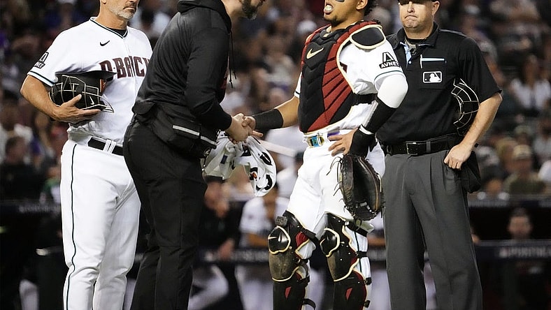 Oct 11, 2023; Phoenix, AZ, USA; Arizona Diamondbacks catcher Gabriel Moreno (14) reacts to an injury against the Los Angeles Dodgers in the fifth inning during Game 3 of the NLDS at Chase Field. Mandatory Credit: Rob Schumacher-Arizona Republic