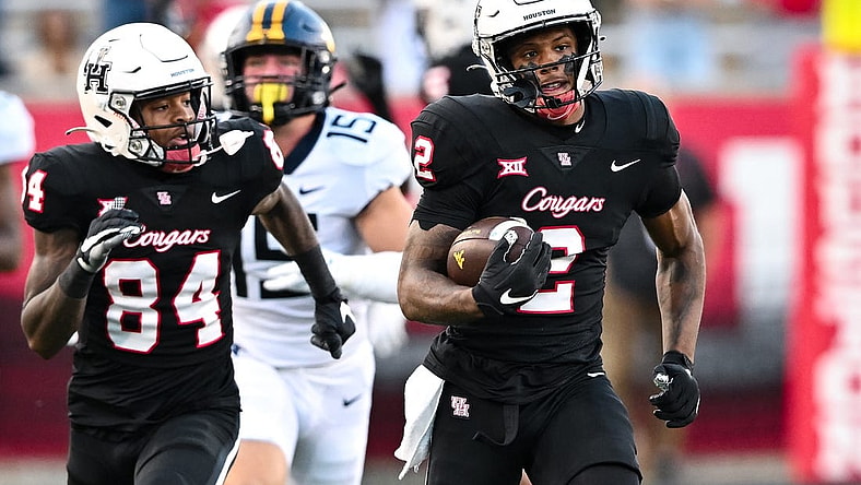 Oct 12, 2023; Houston, Texas, USA; Houston Cougars wide receiver Matthew Golden (2) runs the ball back for a touchdown on a kick off during the first quarter against the West Virginia Mountaineers  at TDECU Stadium. Mandatory Credit: Maria Lysaker-USA TODAY Sports