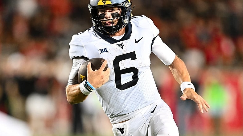 Oct 12, 2023; Houston, Texas, USA; West Virginia Mountaineers quarterback Garrett Greene (6) runs the ball in for a touchdown during the fourth quarter against the Houston Cougars  at TDECU Stadium. Mandatory Credit: Maria Lysaker-USA TODAY Sports