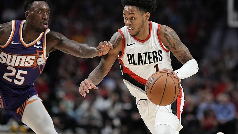 Oct 12, 2023; Portland, Oregon, USA; Portland Trail Blazers shooting guard Anfernee Simons (1) dribbles the ball while defended by Phoenix Suns small forward Nassir Little (25) during the first half at Moda Center. Mandatory Credit: Soobum Im-USA TODAY Sports