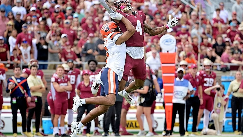 Oct 14, 2023; Tallahassee, Florida, USA; Florida State Seminoles wide receiver Keon Coleman (4) catches a pass over Syracuse Orange defensive back Jason Simmons Jr. (6) during the first quarter at Doak S. Campbell Stadium. Mandatory Credit: Melina Myers-USA TODAY Sports
