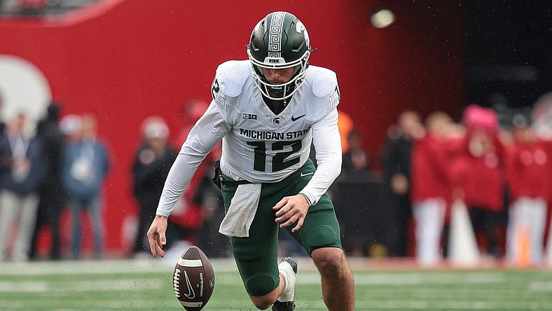 Oct 14, 2023; Piscataway, New Jersey, USA; Michigan State Spartans quarterback Katin Houser (12) recovers his own fumble for a first down during the first half against the Rutgers Scarlet Knights at SHI Stadium. Mandatory Credit: Vincent Carchietta-USA TODAY Sports