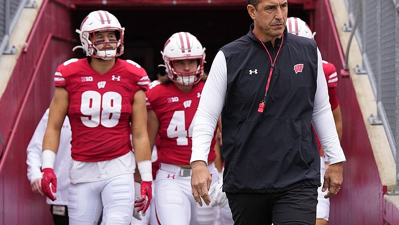 Oct 14, 2023; Madison, Wisconsin, USA;  Wisconsin Badgers coach Luke Fickell leads the football team onto the field for warmups prior to the game against the Iowa Hawkeyes at Camp Randall Stadium. Mandatory Credit: Jeff Hanisch-USA TODAY Sports