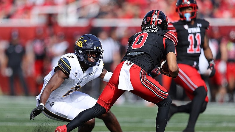 Oct 14, 2023; Salt Lake City, Utah, USA; California Golden Bears defensive back Craig Woodson (2) tackles Utah Utes wide receiver Mikey Matthews (0) in the second quarter at Rice-Eccles Stadium. Mandatory Credit: Rob Gray-USA TODAY Sports