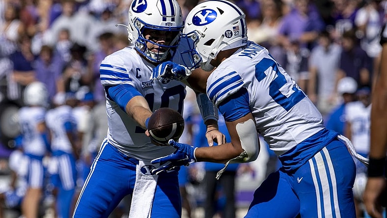 Oct 14, 2023; Fort Worth, Texas, USA; Brigham Young Cougars quarterback Kedon Slovis (10) hands the ball off to running back LJ Martin (27) during the game at Amon G. Carter Stadium. Mandatory Credit: Jerome Miron-USA TODAY Sports