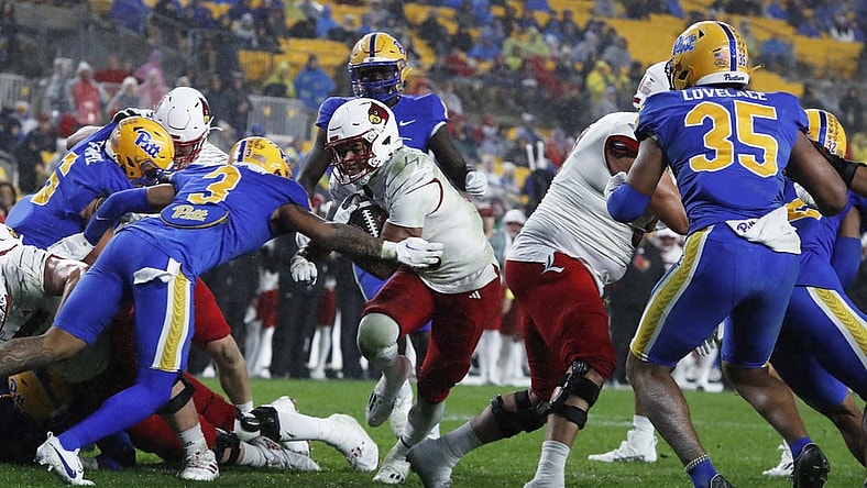 Oct 14, 2023; Pittsburgh, Pennsylvania, USA; Louisville Cardinals running back Isaac Guerendo (middle) scores a touchdown against the Pittsburgh Panthers during the second quarter at Acrisure Stadium. Mandatory Credit: Charles LeClaire-USA TODAY Sports