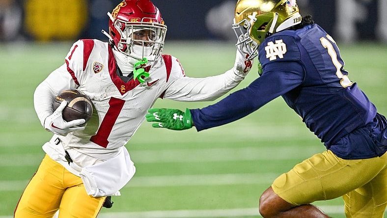 Oct 14, 2023; South Bend, Indiana, USA; USC Trojans wide receiver Zachariah Branch (1) carries as Notre Dame Fighting Irish safety Ramon Henderson (11) defends in the first quarter at Notre Dame Stadium. Mandatory Credit: Matt Cashore-USA TODAY Sports