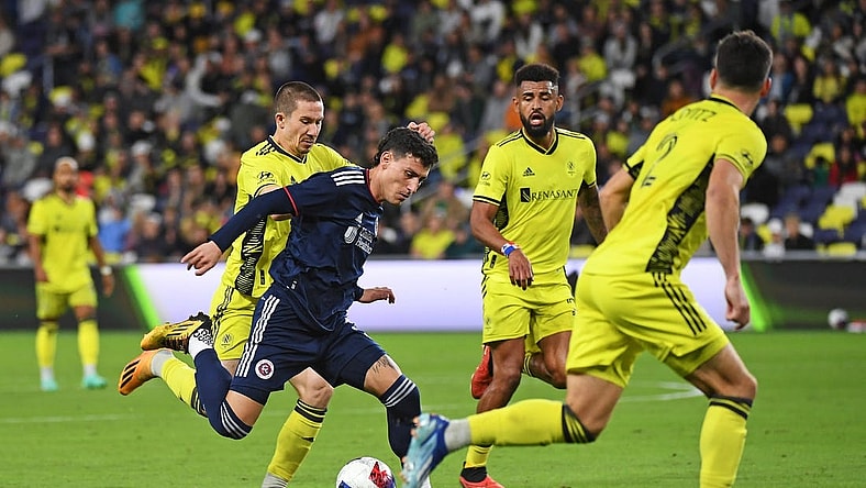 Oct 14, 2023; Nashville, Tennessee, USA; New England Revolution forward Tomas Chancalay (5) and Nashville SC midfielder Alex Muyl (19) battle for the ball during the first half at Geodis Park. Mandatory Credit: Christopher Hanewinckel-USA TODAY Sports